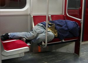 A mentally handicapped homeless man sleeps on ...