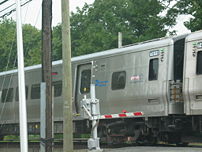 LIRR train is approaching a station through a ...